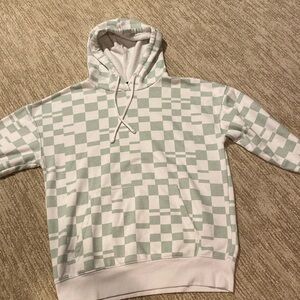 Green white checkered hoodie sweatshirt. Size large. Used. Small stain on sleeve